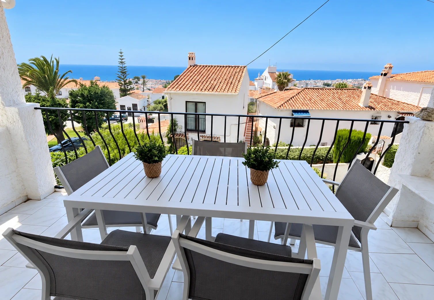 Outdoor dining table on the terrace with Mediterranean sea views