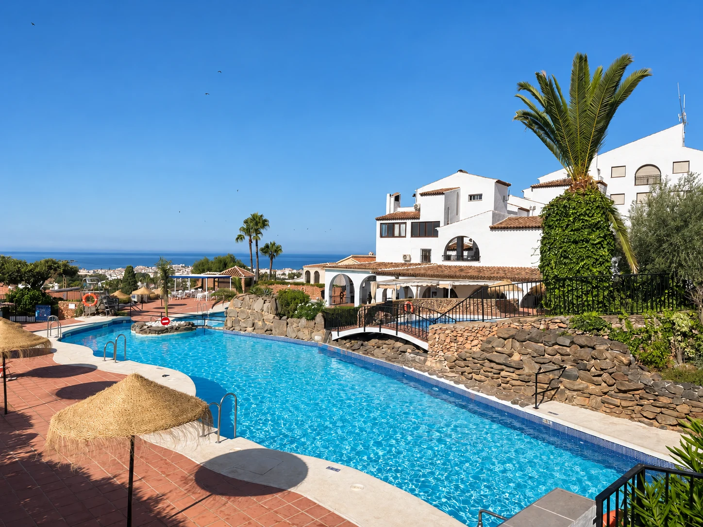 Shared swimming pool among the white houses of Capistrano Village